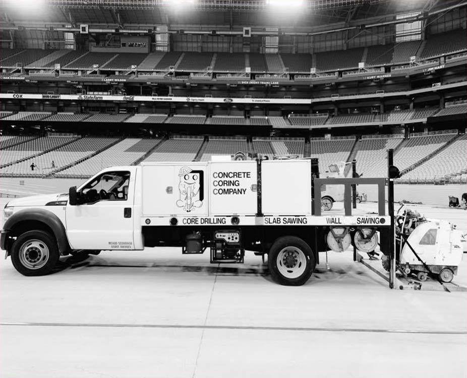 Concrete Coring Company truck and slab saw parked on the field at Cardinals Stadium in Glendale, Arizona