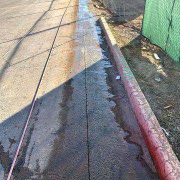 A straight saw cut along a curb line