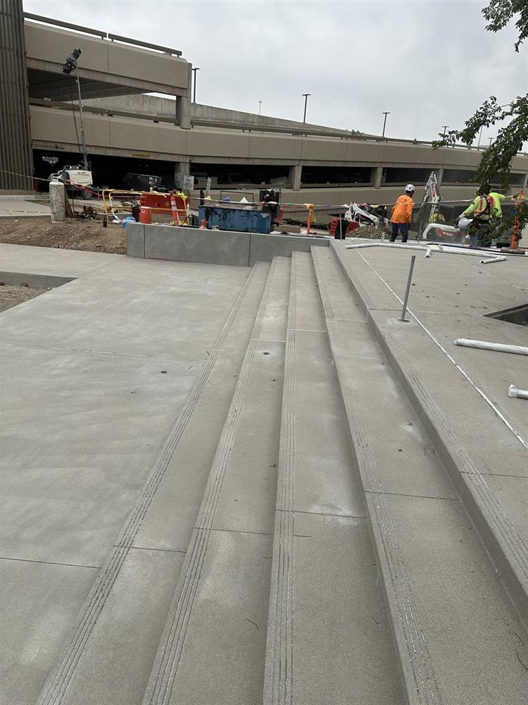 The long run of new steps at Glendale City Hall with every handrail post location cored, April 2026