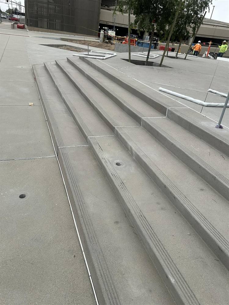 New concrete steps at Glendale City Hall with 3-inch cores drilled in the treads for handrail posts, April 2026