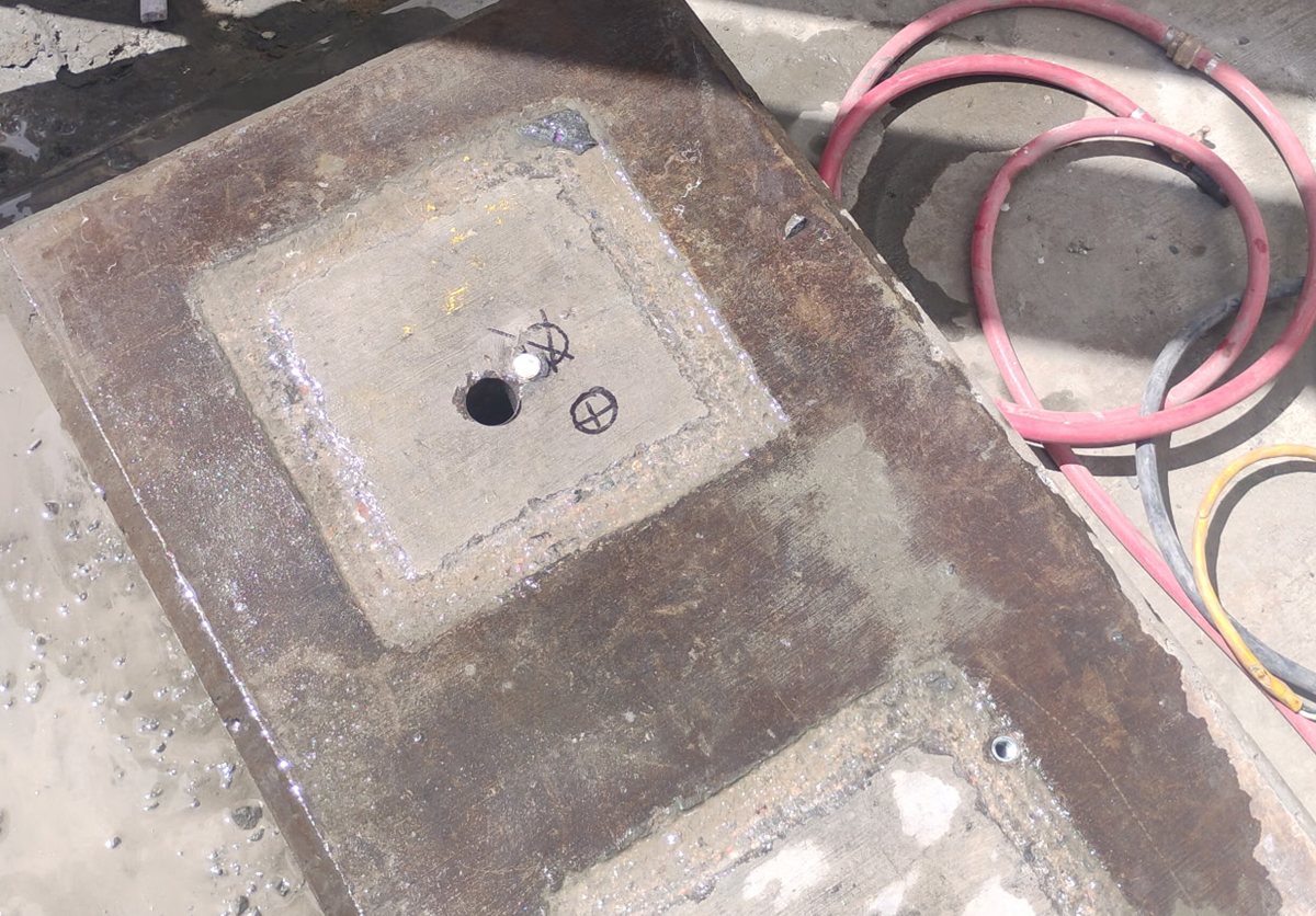 Clean anchor hole drilled through the pocket of a steel machine base at Origin Mining in Golden Valley, Arizona