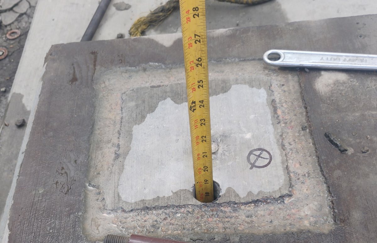 Tape measure in an eighteen inch deep anchor hole at a mine in Golden Valley, Arizona