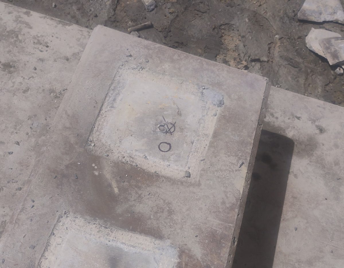 Concrete machine pedestal with anchor pockets and a drilled hole at a Golden Valley mine