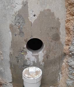 Clean core hole through a precast manhole wall