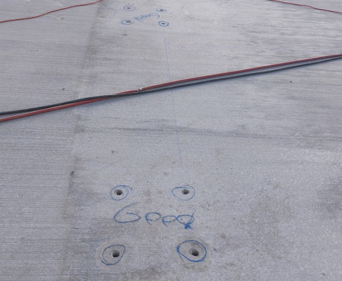 Groups of four one-inch core drilled anchor holes marked on a new slab at 335 E Pecos Road in Queen Creek