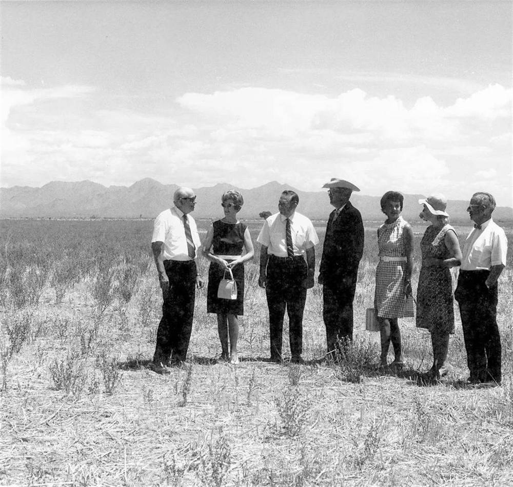 Groundbreaking for Scottsdale Community College in the 1960s, a group standing in an open field with the McDowell Mountains behind