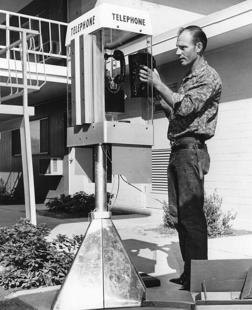 A man at an outdoor pay phone in Scottsdale in the 1960s