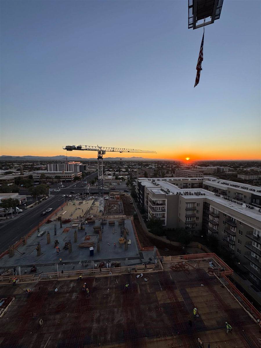 Tower crane over a high-rise deck in downtown Scottsdale at sunrise, the crew getting it ready for the next pour