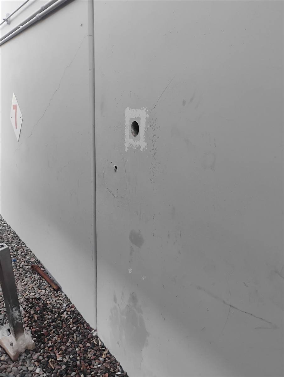 Finished core through the outside wall of a semi-truck plant in Tempe, the wall left clean around it